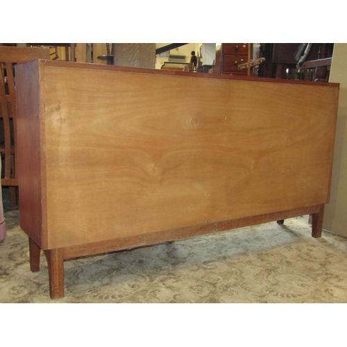 2253 - A good quality unusual mid-20th century afromosia sideboard, of shallow breakfront form, partially f... 