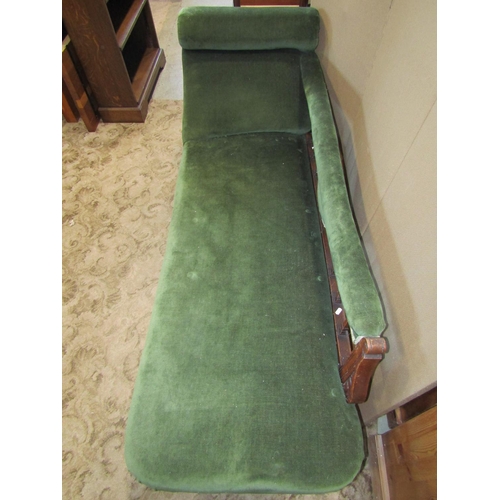 2316 - An Edwardian chaise lounge with green dralon upholstered seat back rail and scrolled headrest, with ... 