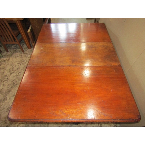 2323 - 19th century rectangular mahogany drop leaf dining table, raised on turned legs with brass caps and ... 