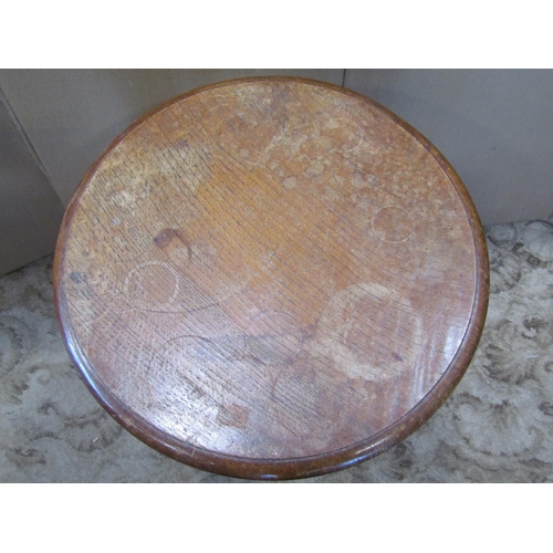 2324 - A Victorian oak occasional table, the circular top with moulded outline raised on a tapered octagona... 