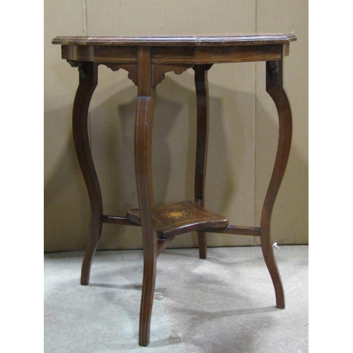 2387 - An inlaid Edwardian rosewood two tier occasional table, the octagonal top with shaped and moulded ou... 