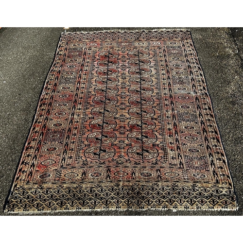 1617 - A faded old Turkoman Tekke carpet with elephant gul on a faded red ground, 207cm x 130cm approx.