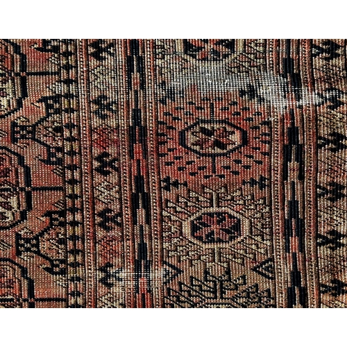 1617 - A faded old Turkoman Tekke carpet with elephant gul on a faded red ground, 207cm x 130cm approx.