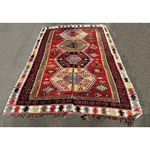 1619 - A large old Kilim with a central row of large diamond medallions in bright repeating colours , faded... 