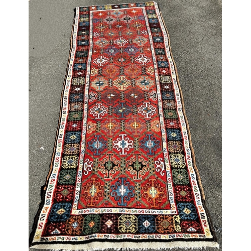 1630 - An old Persian designed runner with repeating geometric pattern to a central panel, 300cm x 95cm app... 