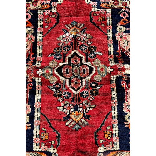 1632 - North West Persian Lillian good condition rug, with a stylised floral medallion on a red ground and ... 