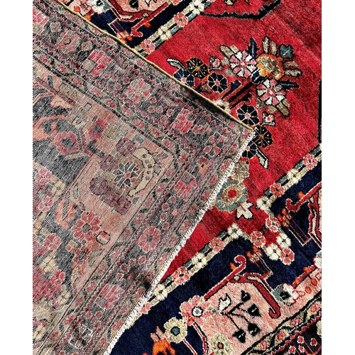 1632 - North West Persian Lillian good condition rug, with a stylised floral medallion on a red ground and ... 