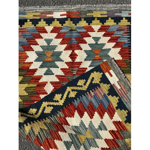 1633 - A Chobi Kilim with a brightly coloured all over geometric pattern, 131cm x 78cm approx