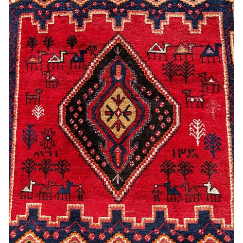 1634 - A Middle Eastern Gabbeh style carpet with a central medallion on a red ground interspersed with styl... 