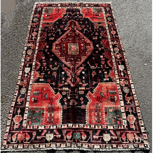 1637 - North West Persian Koliahee good quality rug, with a central elongated lozenge medallion on a dark b... 