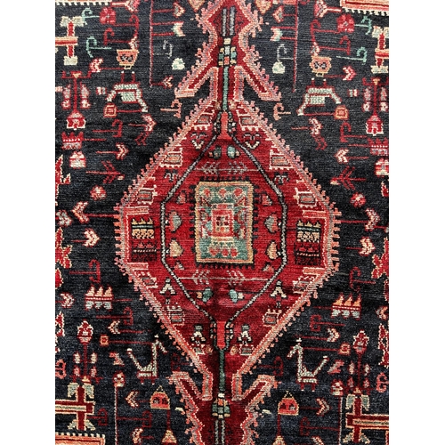 1637 - North West Persian Koliahee good quality rug, with a central elongated lozenge medallion on a dark b... 