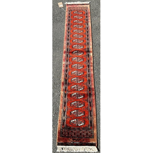 1643 - A Fine Bokhara Runner with eighteen central gul on a predominantly orange ground, 188cm x 32cm appro... 