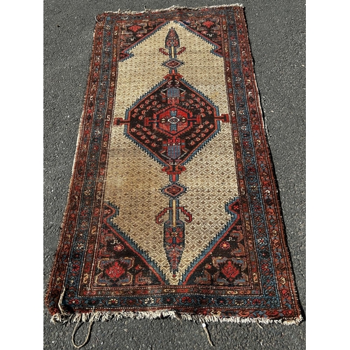 1649 - A faded old Kazak carpet an elongated lozenge central medallion, 195cm x 96cm approx and a small mac... 