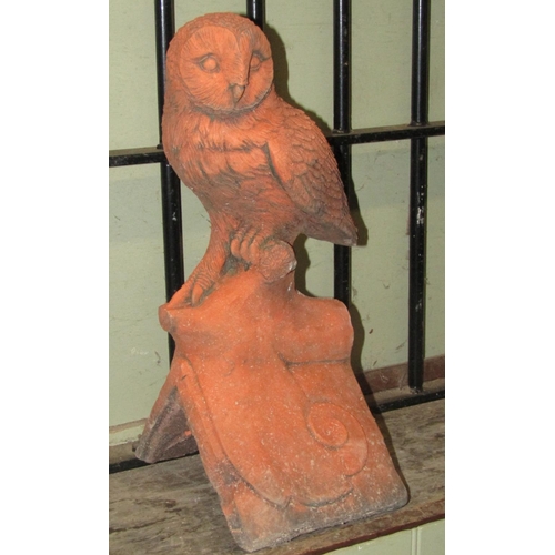 2072 - A simulated terracotta ridge tile with owl surmount, 43cm high