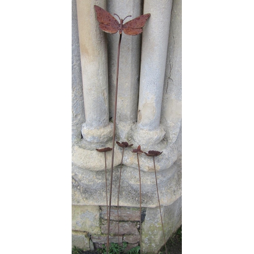 2073 - An ornamental heavy gauge steel border stake with floating butterfly finial, together with four smal... 