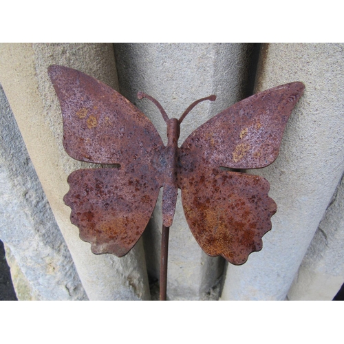 2073 - An ornamental heavy gauge steel border stake with floating butterfly finial, together with four smal... 