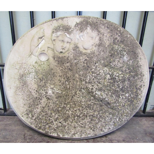 2078 - A weathered cast composition stone oval wall mounted tablet/plaque with raised relief frolicking che... 