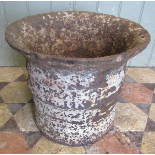 2086 - A weathered antique heavy gauge cast iron mortar with flared rim, ribbed detail and traces of over p... 