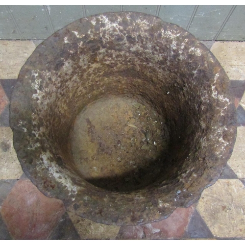 2086 - A weathered antique heavy gauge cast iron mortar with flared rim, ribbed detail and traces of over p... 