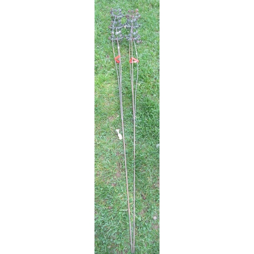 2092 - A pair of ornamental three stemmed heavy gauge steel border stakes, 180cm high