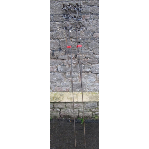 2092 - A pair of ornamental three stemmed heavy gauge steel border stakes, 180cm high