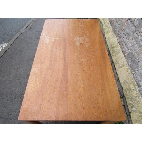 2358 - A light Ercol elm and beechwood cottage dining table of rectangular form raised on simple turned sup... 