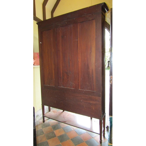 2557 - A good quality Edwardian mahogany display cabinet of full height, the central door with applied moul... 