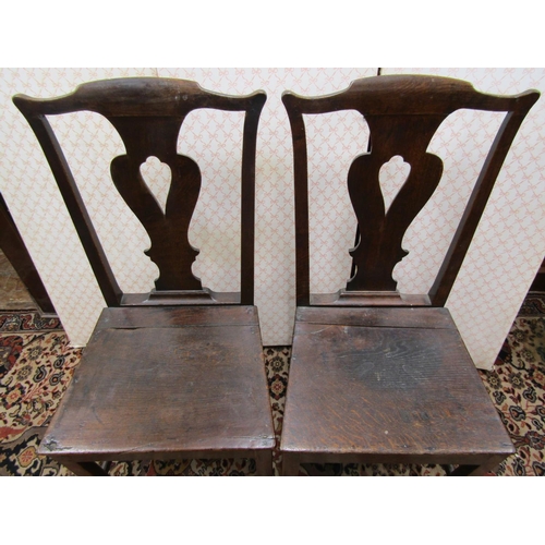 2565 - A pair of Georgian oak cottage chairs with pierced vase shaped splats and solid seats with square cu... 