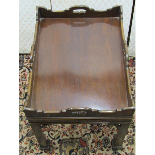 2573 - An antique style butlers tray enclosing two side slides, set on square cut frames and stepped feet, ... 