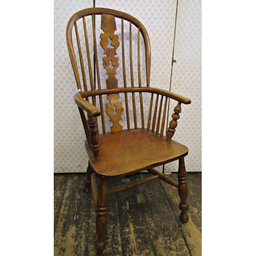 2574 - A Georgian comb back elbow chair in mixed timbers principally ash, with an elm seat on turned suppor... 