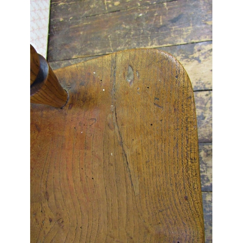 2574 - A Georgian comb back elbow chair in mixed timbers principally ash, with an elm seat on turned suppor... 