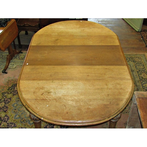 2577 - A Victorian oak extending dining table with two additional leaves, with D ends, raised on four carve... 