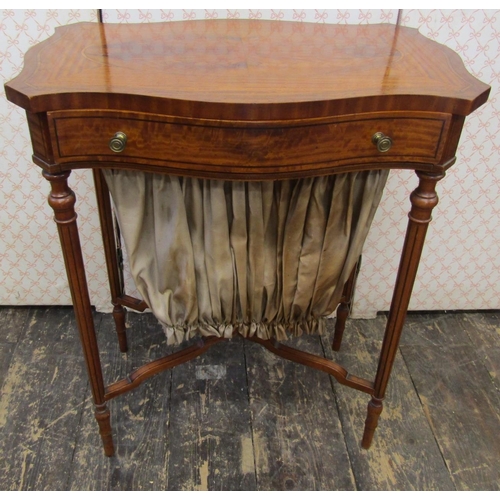 2590 - A late 19th century satinwood ladies sewing table of serpentine form, the top with quarter veneered ... 