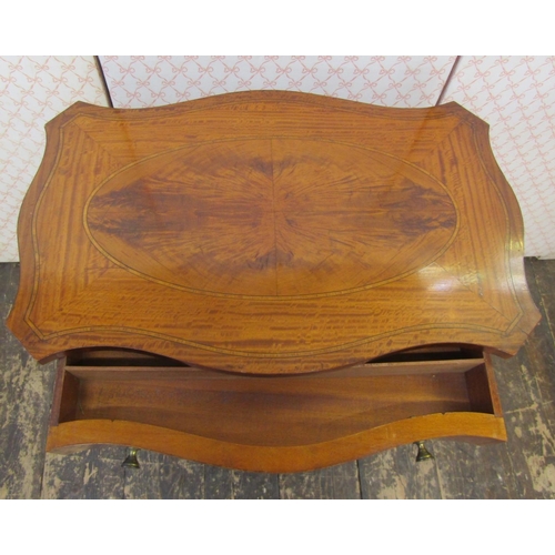 2590 - A late 19th century satinwood ladies sewing table of serpentine form, the top with quarter veneered ... 