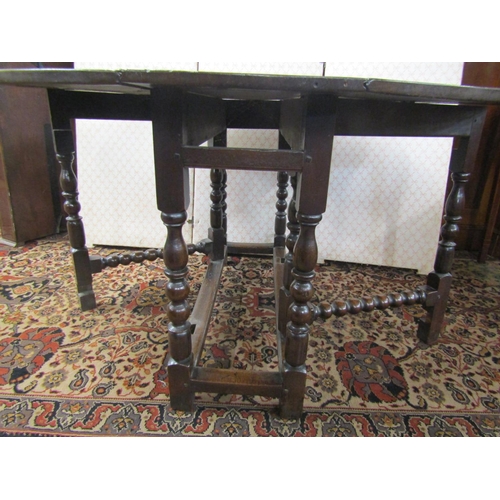 2592 - A Georgian oak gateleg table of narrow proportions, with shallow carved banded borders, 110cm long x... 