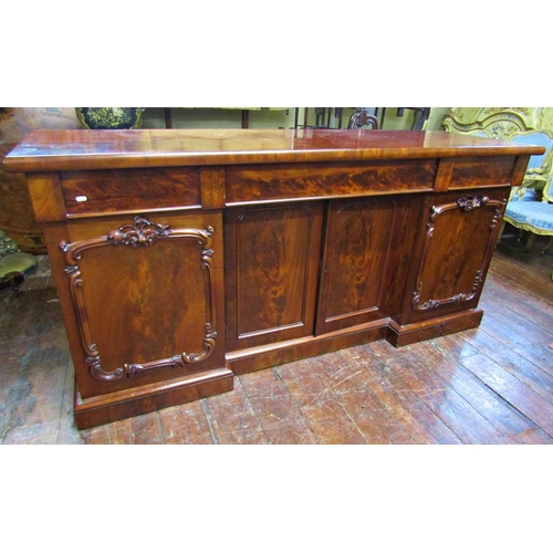 2607 - A Victorian mahogany inverted breakfront four door sideboard with applied and carved detail, with th... 