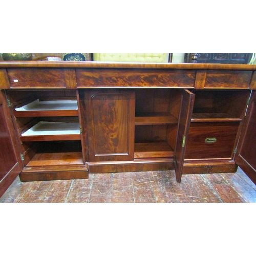 2607 - A Victorian mahogany inverted breakfront four door sideboard with applied and carved detail, with th... 