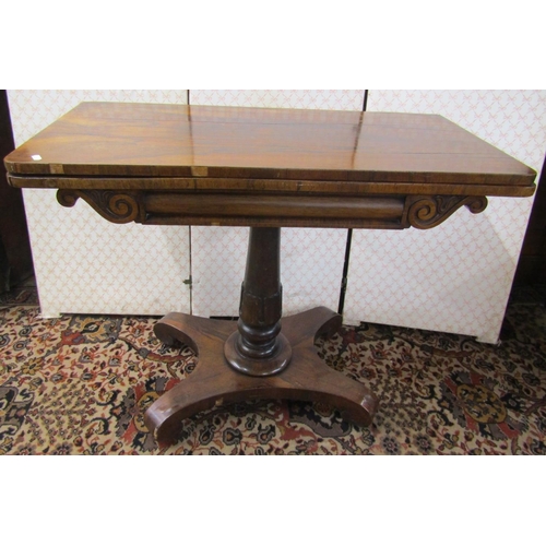 2609 - A Regency rosewood foldover top card table, raised on turned column and platform base