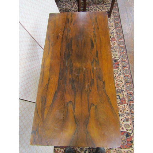 2609 - A Regency rosewood foldover top card table, raised on turned column and platform base