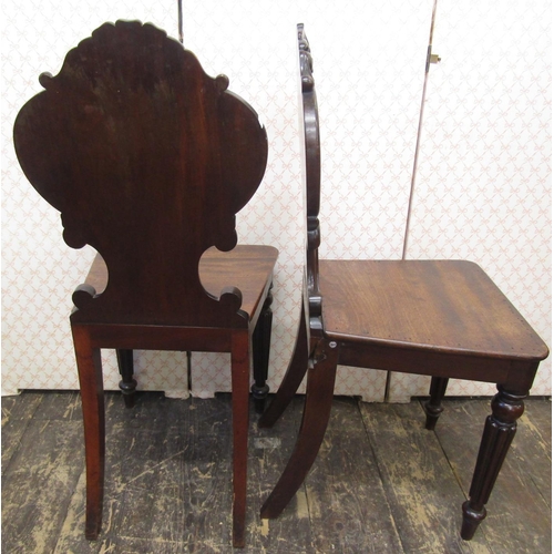 2621 - A pair of Regency mahogany hall chairs, the shaped backs with C scroll, acanthus and other detail, o... 