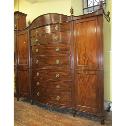 2624 - A Georgian mahogany gentleman's wardrobe, the central tower of six long and two short drawers with b... 