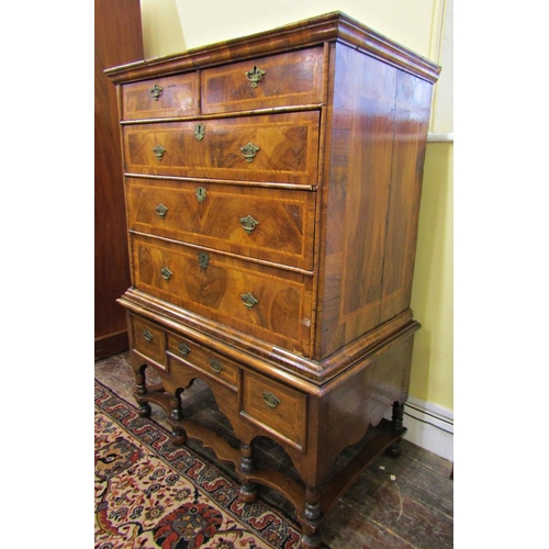 2631 - A Georgian walnut chest on stand, the chest of three long and two short drawers, the stand incorpora... 