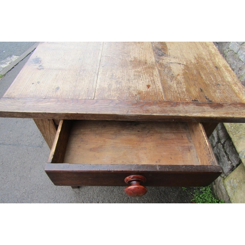 2637 - An old oak farmhouse table, the plank top with cleated ends, raised on four square tapered legs encl... 