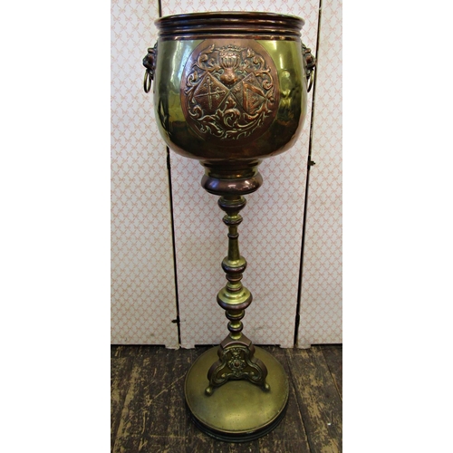 2643 - A late 19th century brass and overlaid copper jardinière and stand, the upper section with lion mask... 