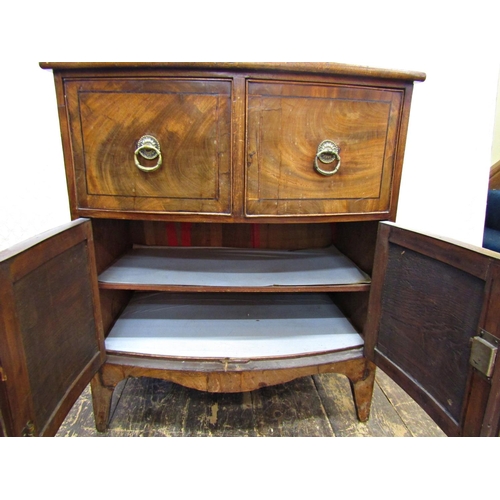 2652 - A Georgian mahogany bowfront side cupboard enclosed by a pair of panelled doors and two drawers, wit... 