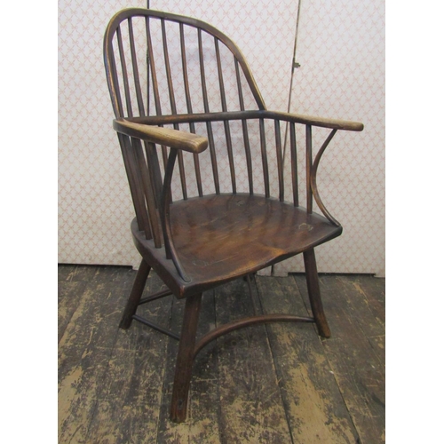 2654 - An 18th century Windsor hoop back elbow chair, principally in ash, the simple stick supports united ... 