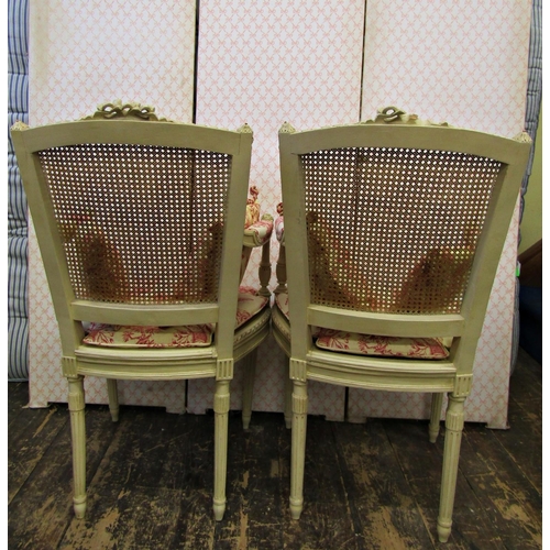 2661 - A pair of open frame salon chairs with carved and painted framework, cane panelled seats and back, a... 