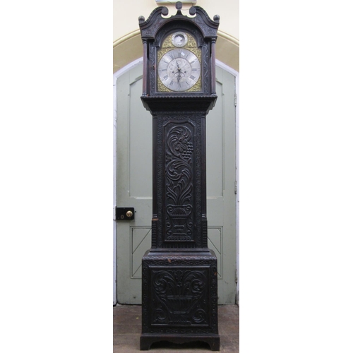 2662 - An early 19th century oak longcase clock, the casework with later geometric carved detail, enclosing... 