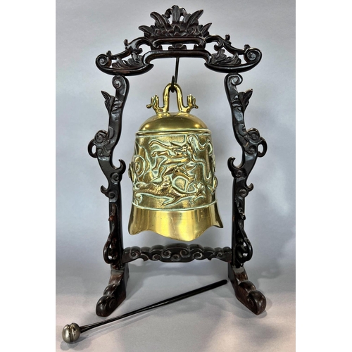 1506 - A Chinese brass gong with carved dragon detail, hung from a hardwood stand, with striker, 38cm high.