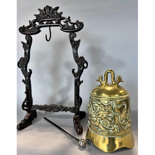 1506 - A Chinese brass gong with carved dragon detail, hung from a hardwood stand, with striker, 38cm high.